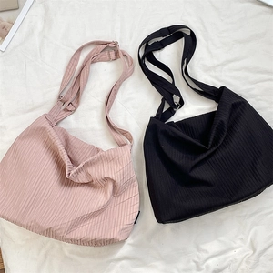 Detailed texture of knitted ribbed canvas tote bags with adjustable wide shoulder straps