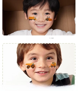 Detailed close-up of cartoon construction vehicle temporary tattoos on child's arm