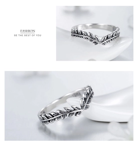 Macro detail of V-shaped S925 sterling silver ring with vintage olive leaf texture