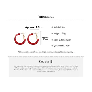 Detailed view of red enamel C-shaped hoop earrings with silver pins and size dimensions