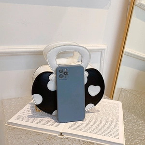 Cute heart-shaped black and white shoulder bag with metal chain and single handle