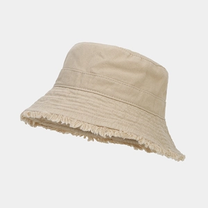 Detail view of khaki cotton bucket hat with distinctive frayed edges and minimalist style