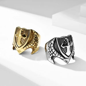 Detailed view of vintage gold and silver cross shield rings with wing textures