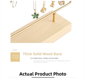 Close-up of 7cm thick solid wood base and golden metal bar of the jewelry stand