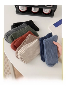 Detail showing various colors of men's cotton crew socks with breathable double-needle knit
