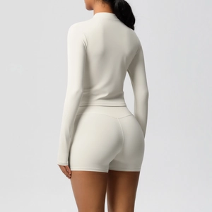 Detail view of cream slim-fit yoga set showing back contouring and peach lift seams