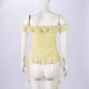 Close-up of bright yellow off-shoulder top featuring tiered ruffles and pleated texture