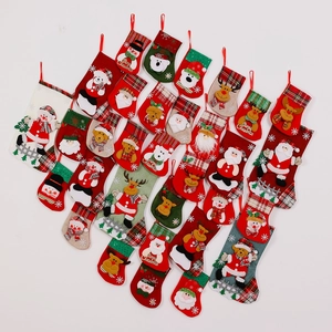 Assorted Christmas stockings with Santa, snowman, and reindeer patterns on white background