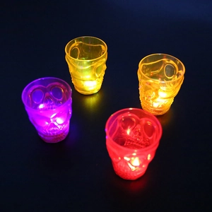 Glow-in-the-dark skull shot glasses in purple, yellow, orange and red LED lights