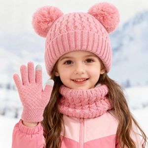 Detail of pink knitted winter set for kids with pompom hat and touchscreen gloves