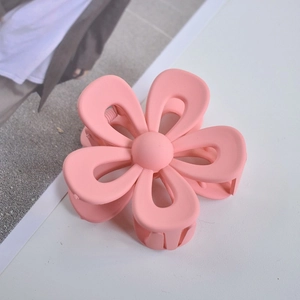 Close-up of pink flower hair claw clip with a matte finish and smooth petal design