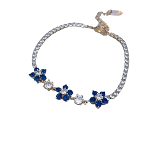 Elegant floral silver bracelet with blue zircon petals and sparkling crystal chain link