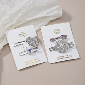 Detailed set of silver rhinestone hair clips including heart shapes and letter designs