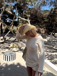 Chic beige long sleeve knitted mini dress with waist tie and bohemian straw hat accessory