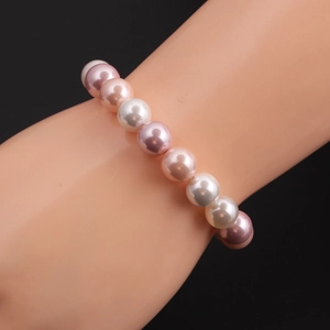 Detail of multi-color pearl beaded bracelet on wrist featuring pink and white pearls