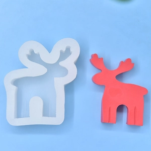 Macro detail of a 3D reindeer silicone mold with a finished red resin Christmas ornament