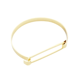Bracciale rigido dorato in rame con design geometrico ovale e finitura minimalista