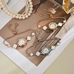 Three mother-of-pearl quartz bracelet watches with clover motifs in gold and rose gold