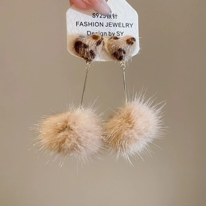 Detail of leopard print heart and beige pompom drop earring with S925 silver needle