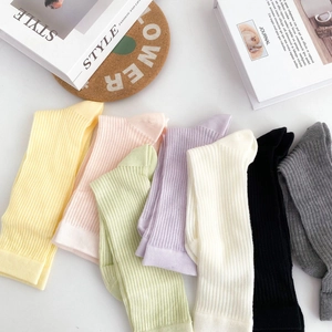 Detailed flat lay of thin cotton socks in various candy colors with ribbed texture fabric