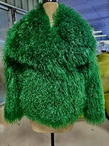 Detail of bright green faux fur jacket with thick curly plush texture on a mannequin