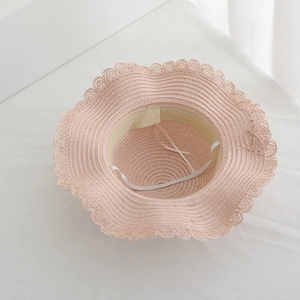 Pink woven straw sun hat with wavy lace trim and elastic chin strap for women