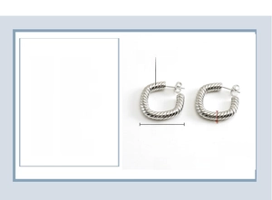 Close-up of 24x5mm twisted texture stainless steel hoop earrings in polished steel finish