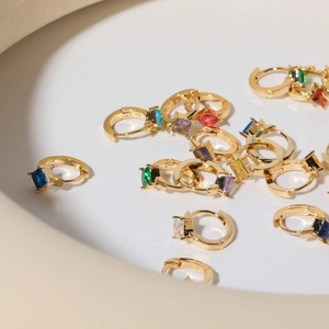Multicolor diamond-shaped gemstone hoop earrings with gold-tone metal base in a tray