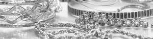 Close-up of bridal jewelry set with silver flower zircon necklace and braided bracelets