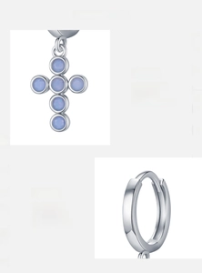 Detail of s925 silver cross earring with iridescent opal stone inlay on gray background