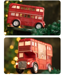 Detail of red Christmas bus ornament with glowing lights and festive interior decor