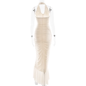 Detail showing the ruched back design and flowing hem of the beige halter dress