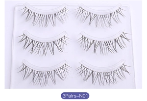 Detailed macro view of 3 pairs of natural crossed false eyelashes with clear bands