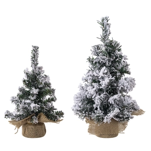 Miniature green snowy Christmas trees set with natural burlap bases for desk decor