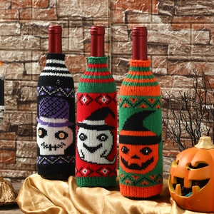 Halloween knitted wine bottle covers with pumpkin, skull, and ghost designs for party decor