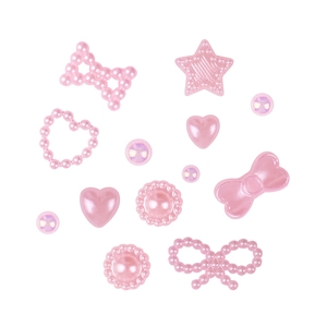 Pastel pink mixed shapes nail art charms including bows, hearts, and stars on white base