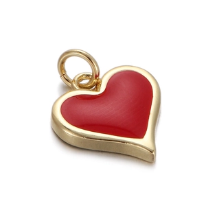 Detailed macro view of a red heart-shaped pendant with polished golden metal frame