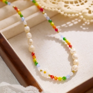 Bohemian colorful pearl beaded necklace with white daisy pendant on jewelry tray