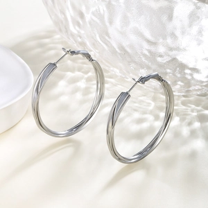 Close-up of silver interlocking triple-hoop earrings with a polished finish