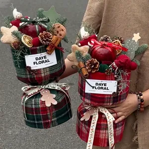 Christmas gift bucket with red green plaid fabric, pine cones and apple decorations