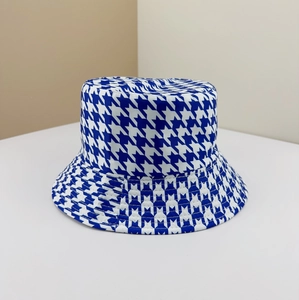 Blue and white houndstooth reversible bucket hat in a minimalist diagonal composition