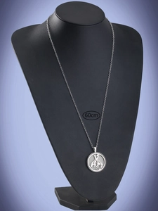 Detail view of silver giraffe pendant on 60cm chain over black jewelry stand