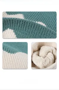 Detail of teal and cream chunky knit winter beanie with thick faux fleece lining