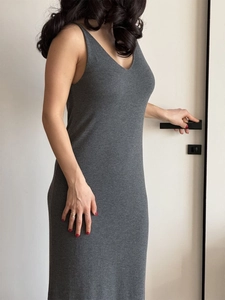 Detail of dark grey knit V-neck sleeveless dress showing fine texture and slim fit