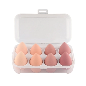 Set of 8 gradient pink teardrop makeup sponges in a transparent storage case