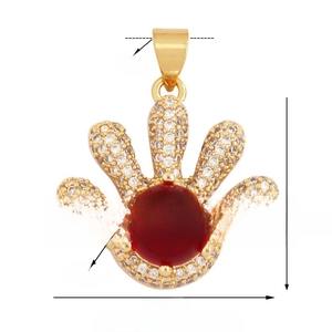 Detail view of Hamsa hand pendant with red stone and dimensions 18mm by 21mm