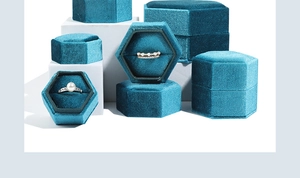Peacock blue velvet hexagonal ring boxes displayed on white geometric stands for jewelry