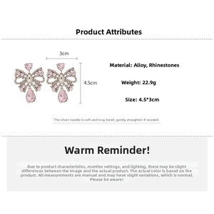 Detail view of pink rhinestone bow earrings with water drop pendant on white background