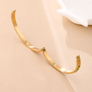 Minimalist gold titanium steel hinged bangle with polished finish and open design for women