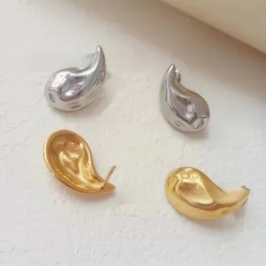 Detailed close-up of 18K gold and silver water drop earrings with a polished mirror finish